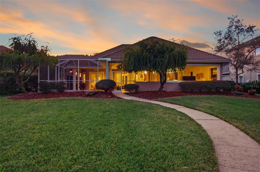 83 Front Street Palm Coast, FL 32137 - Photo 6 of 100 a view of a house with a big yard and palm trees
