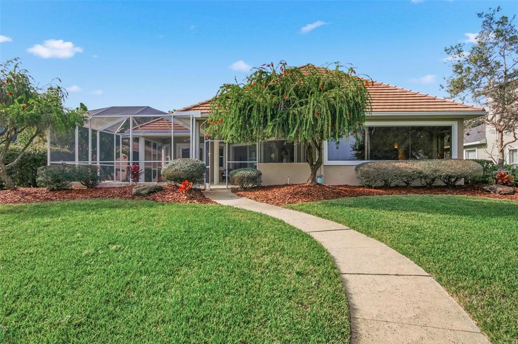 83 Front Street Palm Coast, FL 32137 - Photo 64 of 100 a front view of house with yard and outdoor seating