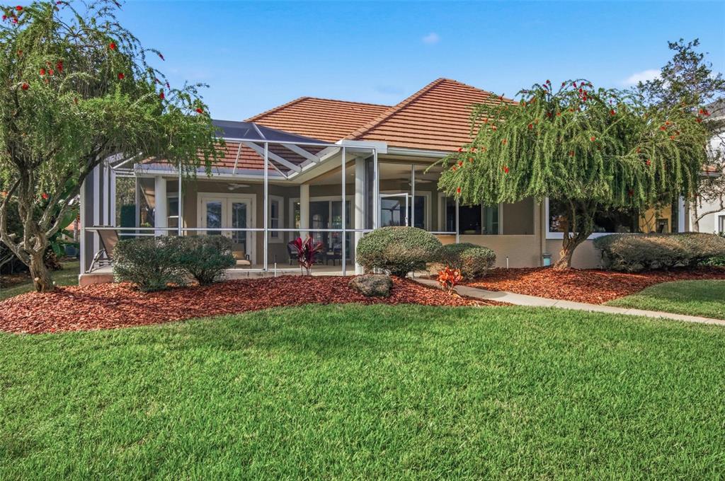 83 Front Street Palm Coast, FL 32137 - Photo 65 of 100 a front view of a house with a yard and porch