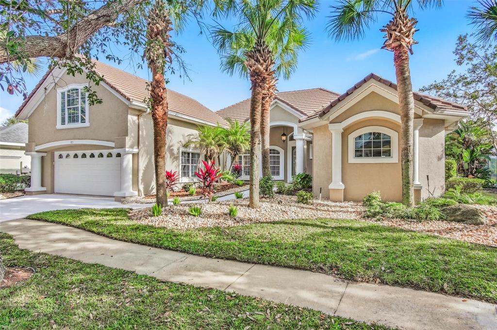 83 Front Street Palm Coast, FL 32137 - Photo 86 of 100 a front view of a house with a yard and garage