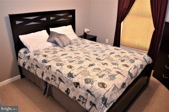 77 Sandyhook Road Ocean Pines, MD 21811 - Photo 20 of 31 a bed sitting in a bedroom next to a window