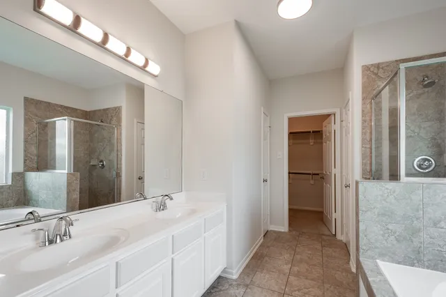 a bathroom with a double vanity sink and a mirror