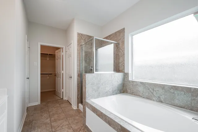 a bathroom with a bathtub and a shower