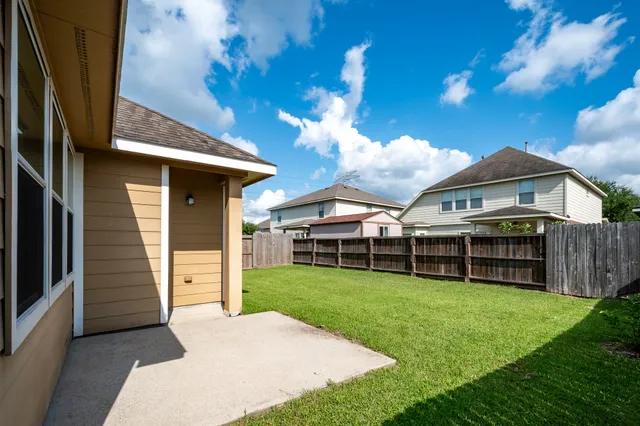 a view of a house with a yard and a garden