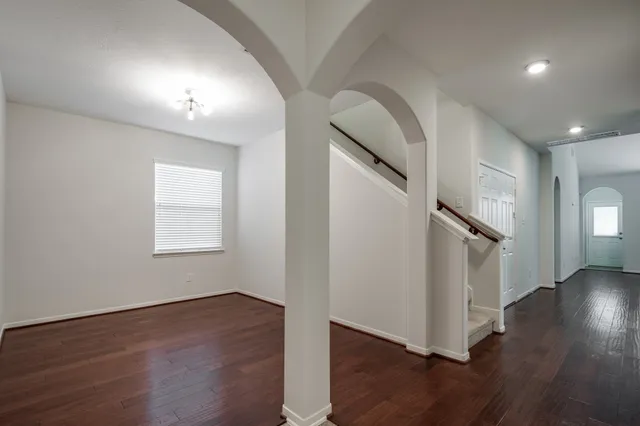 a view of an entryway with wooden floor and staircase