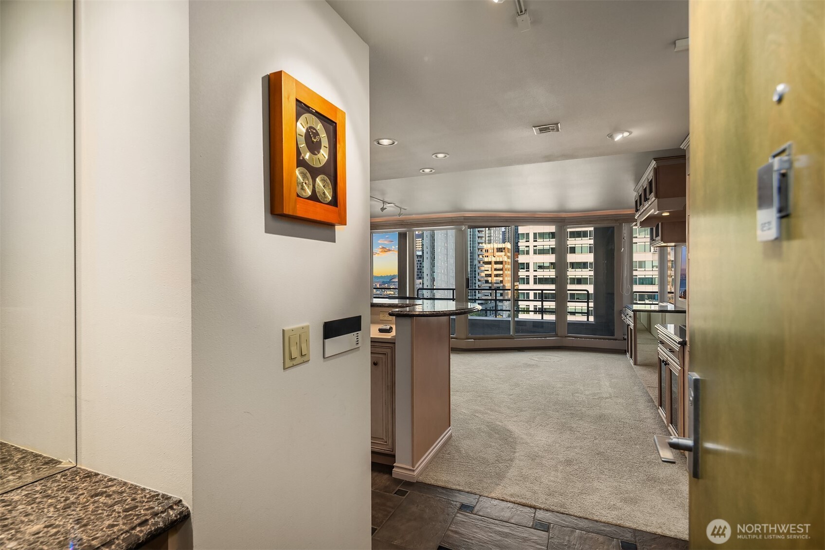 2125 1st Avenue, Unit 1205 Seattle, WA 98121 - Photo 2 of 19 a view of a hallway with wooden shelves