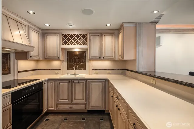 a kitchen that has a sink and a stove in it