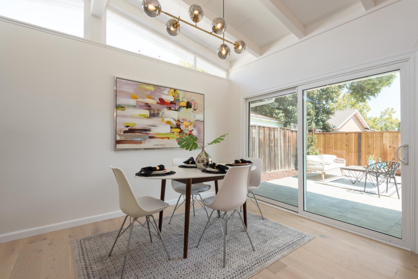 1765 Ravizza Avenue Santa Clara, CA 95051 - Photo 4 of 14 a view of a dining room with furniture large windows and wooden floor