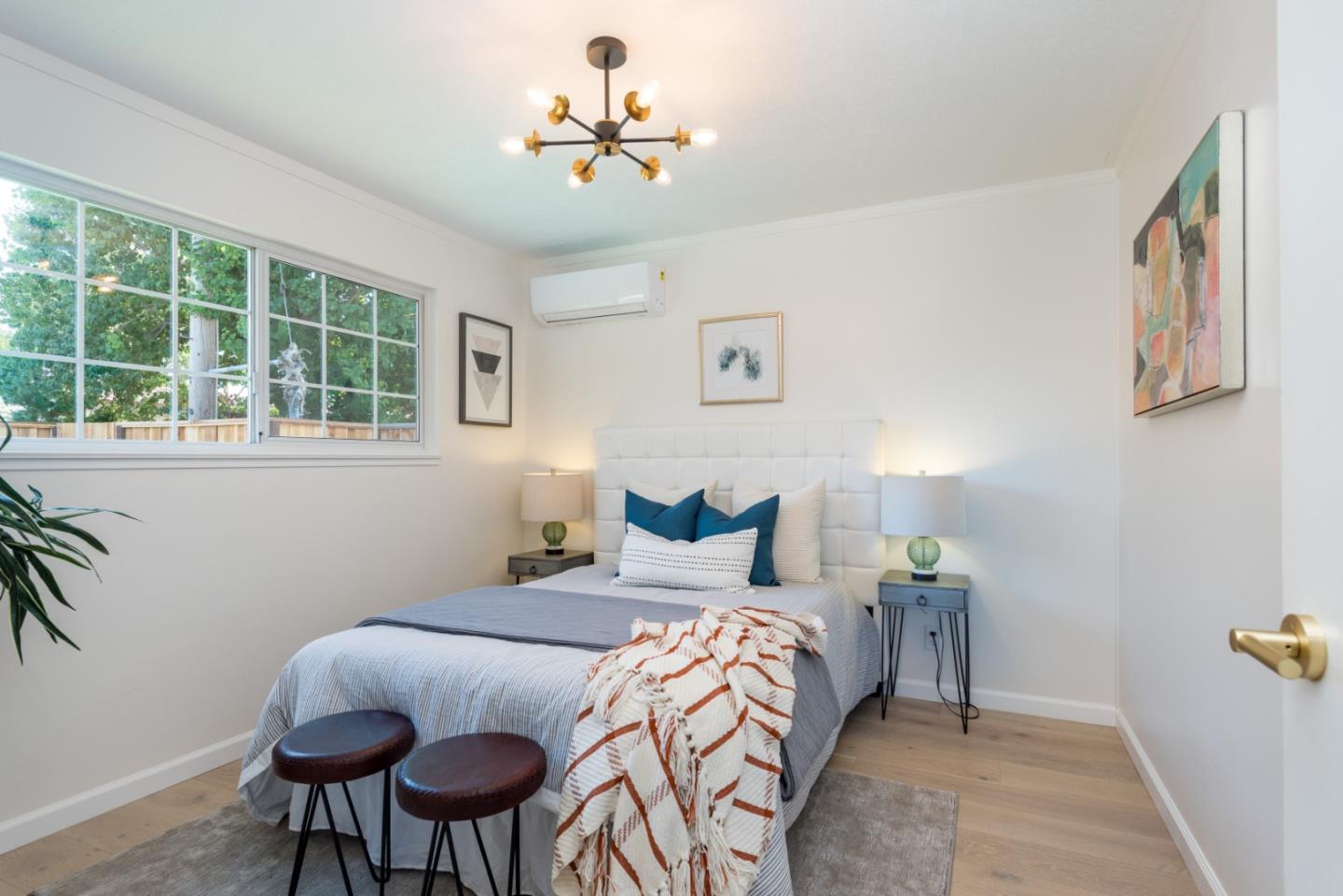 1765 Ravizza Avenue Santa Clara, CA 95051 - Photo 8 of 14 a bedroom with a bed and a chandelier