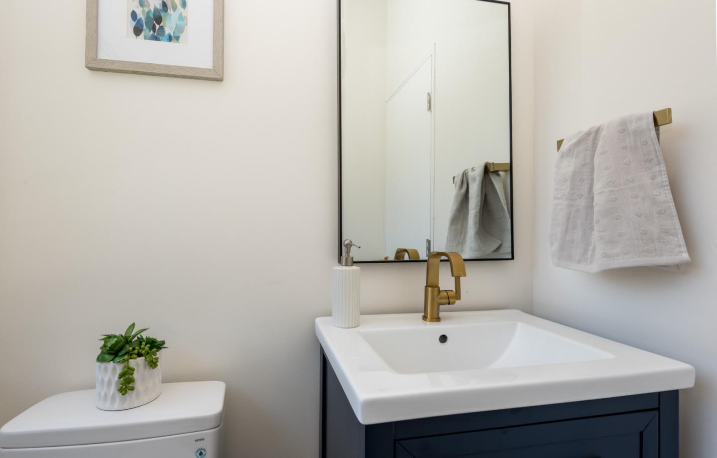 1765 Ravizza Avenue Santa Clara, CA 95051 - Photo 9 of 14 a bathroom with a sink and a mirror