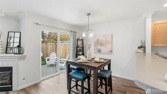 a dining room with furniture a chandelier and wooden floor