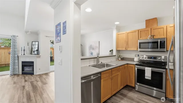 a kitchen with a sink stove and microwave