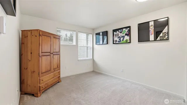 an empty room with windows and closet