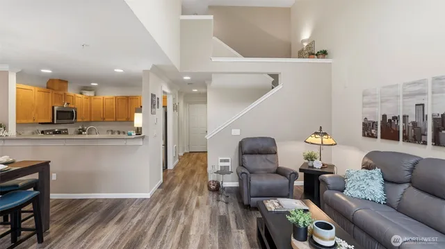 a living room with furniture and kitchen view