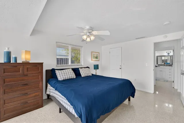 a bedroom with a large bed and a chandelier
