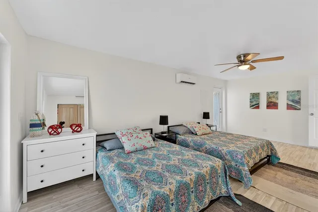 a bedroom with two beds and a dresser