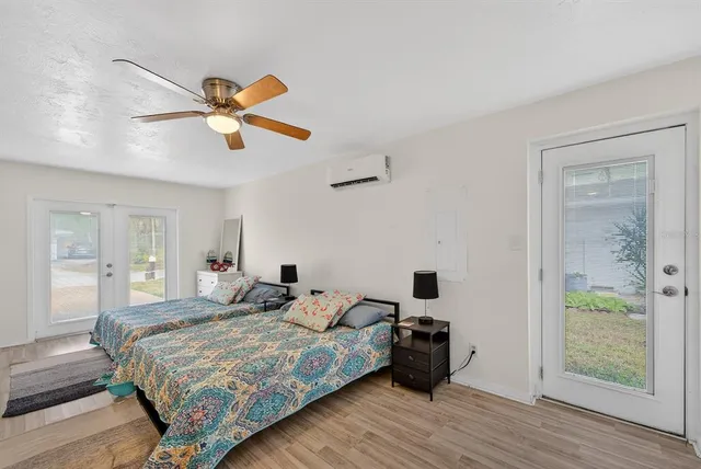 a bedroom with a large bed and a chandelier