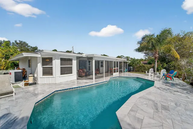 a view of a house with a backyard porch and sitting area