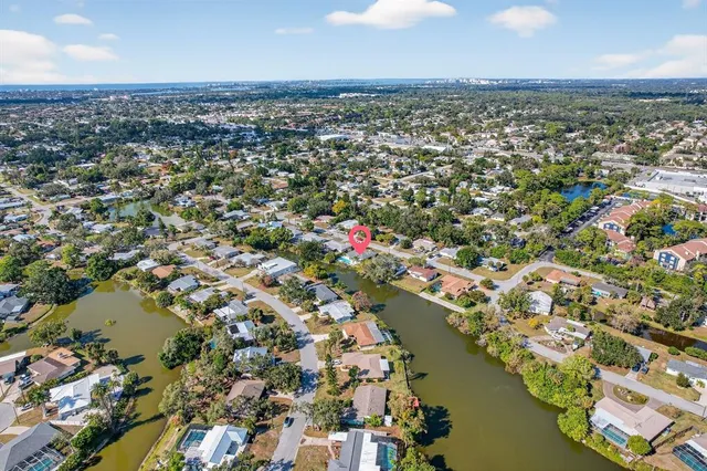 an aerial view of residential houses with outdoor space and lake view