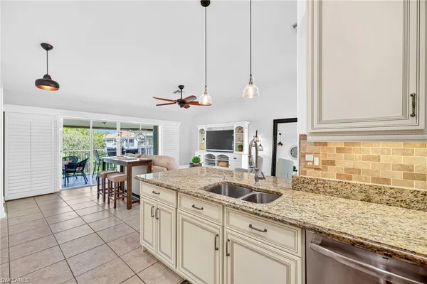 a kitchen with stainless steel appliances granite countertop a sink and cabinets