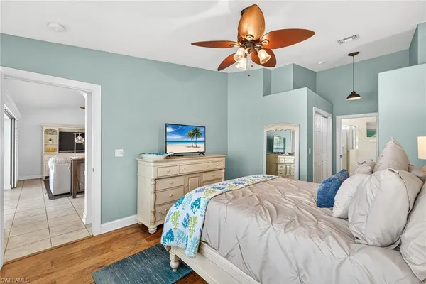 a bedroom with a bed and a chandelier