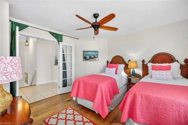 a bedroom with two bed and window