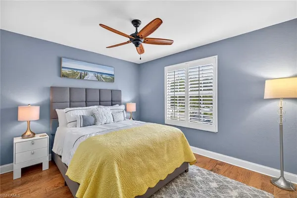 a bedroom with a bed and a lamp