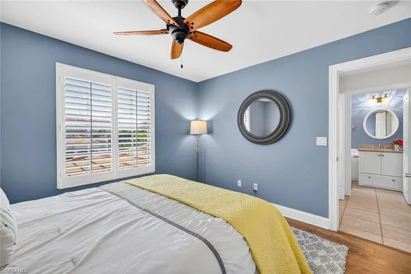 a bedroom with a bed and a mirror