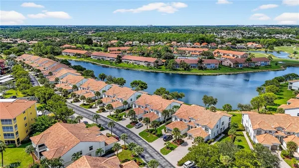 an aerial view of a houses with a lake view