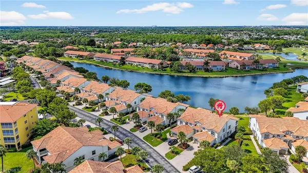 an aerial view of residential houses with outdoor space and river
