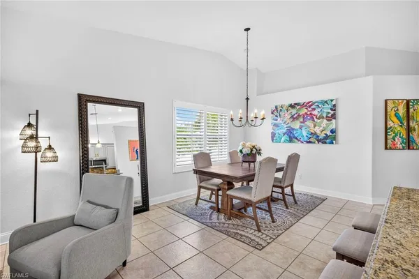 a dining room with furniture and window