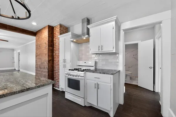 a kitchen with stainless steel appliances granite countertop a stove and a refrigerator