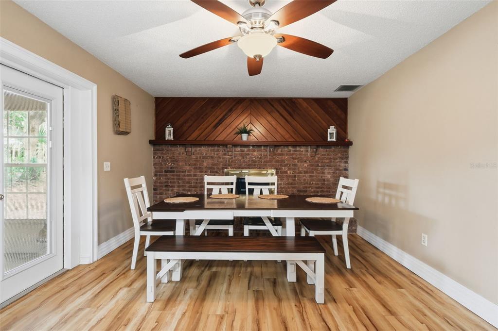 244 Angeles Road DeBary, FL 32713 - Photo 20 of 41 a dining room with a wooden table and chairs