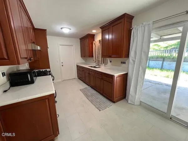 a large kitchen with a sink a stove and a refrigerator
