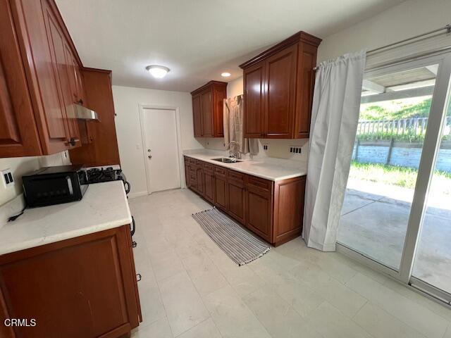 2534 Inca Court Ventura, CA 93001 - Photo 2 of 18 a large kitchen with a sink a stove and a refrigerator