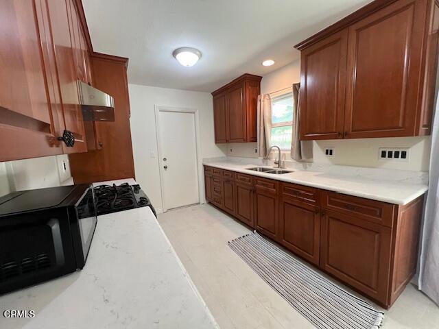 2534 Inca Court Ventura, CA 93001 - Photo 3 of 18 a kitchen with a sink and a stove top oven
