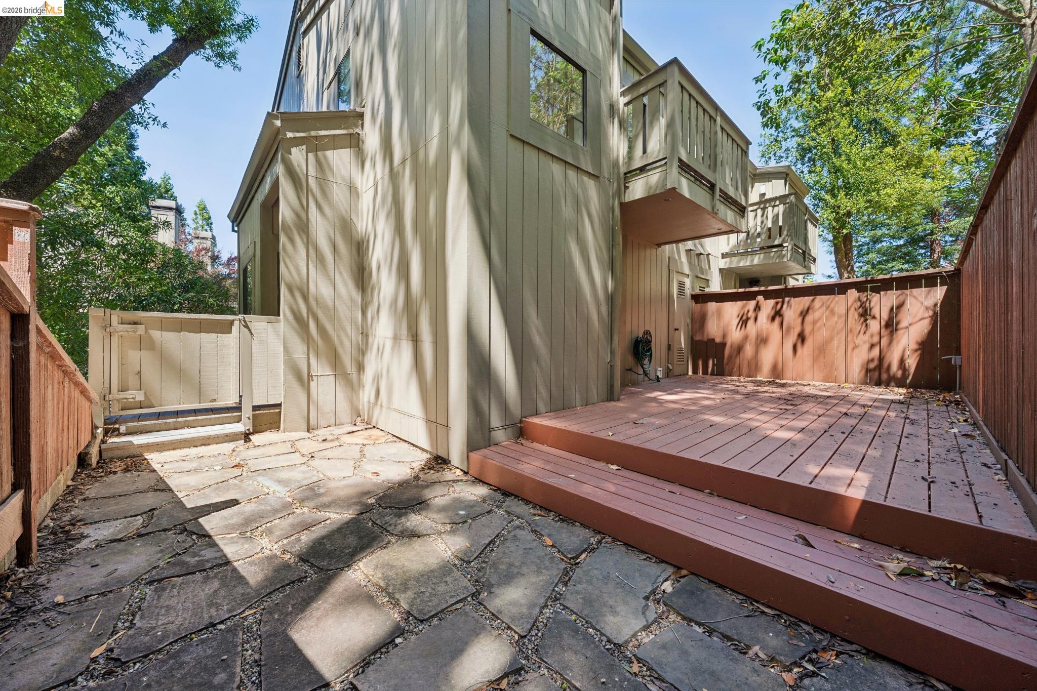 261 Redhawk Road Novato, CA 94949 - Photo 43 of 44 Private outdoor patio featuring a flagstone walkway, elevated wood deck, and wood fencing