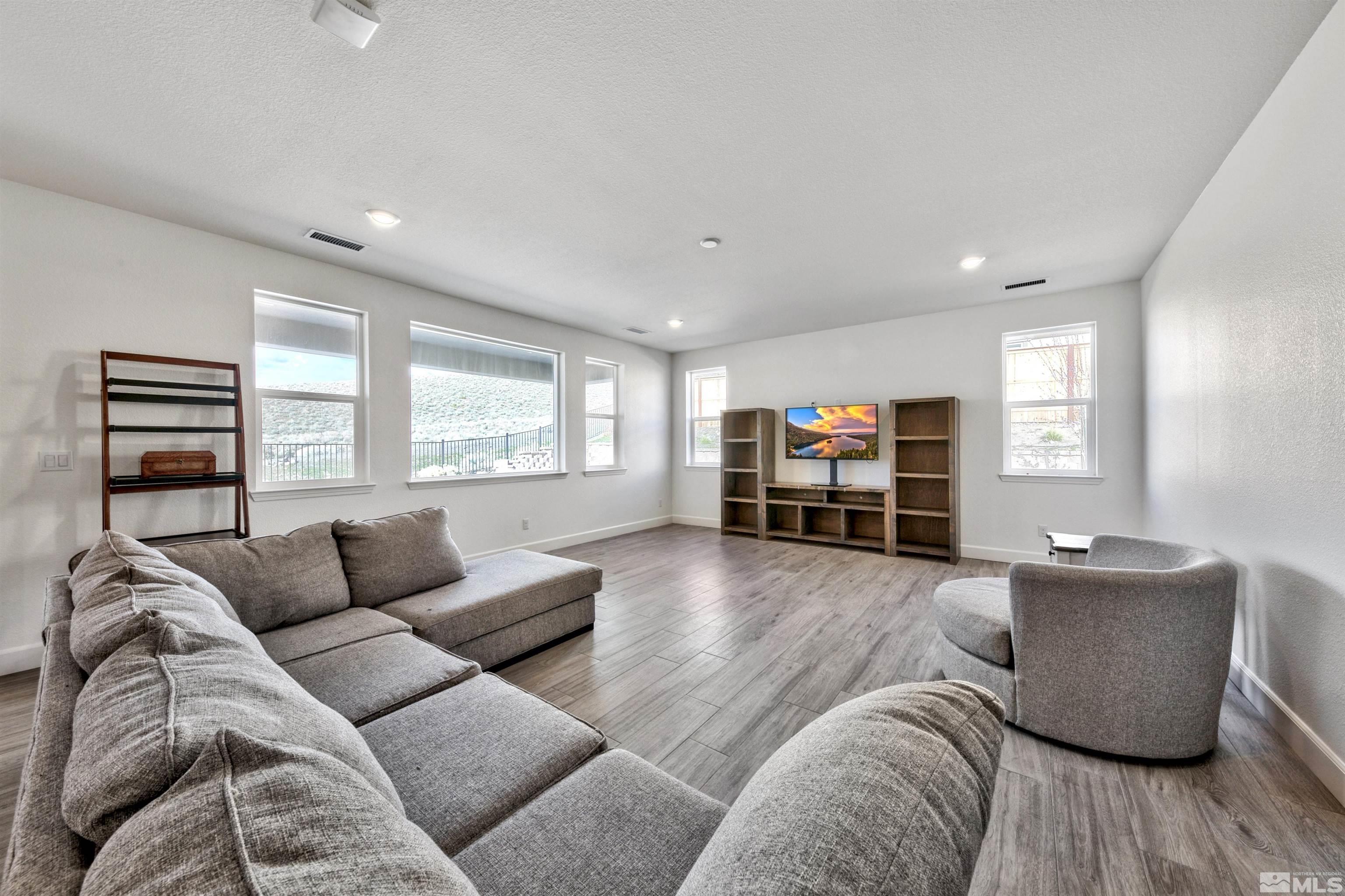 4505 High Pointe Drive Reno, NV 89521 - Photo 11 of 30 a living room with furniture and a flat screen tv