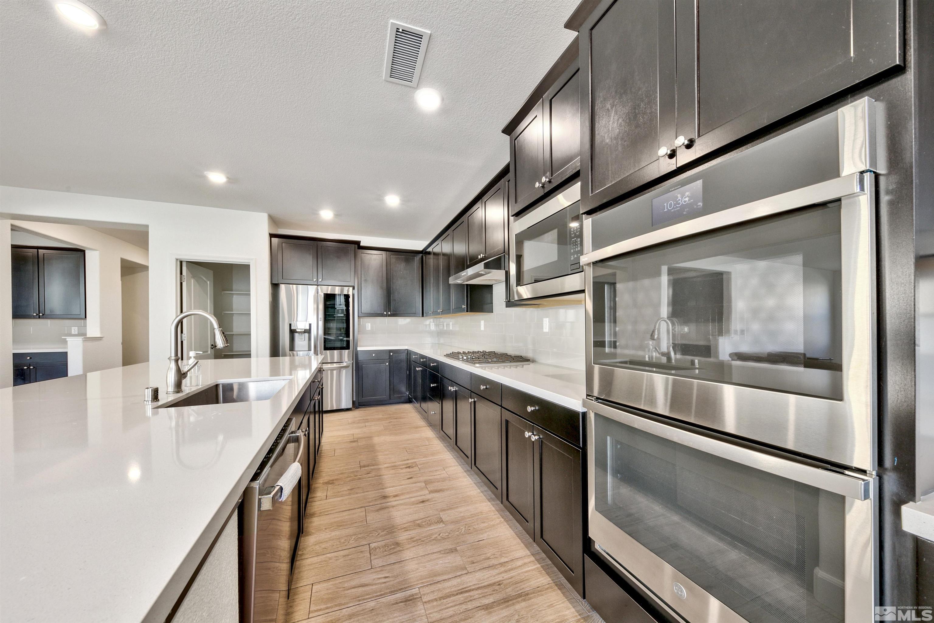 4505 High Pointe Drive Reno, NV 89521 - Photo 18 of 30 a large kitchen with stainless steel appliances and lots of counter space