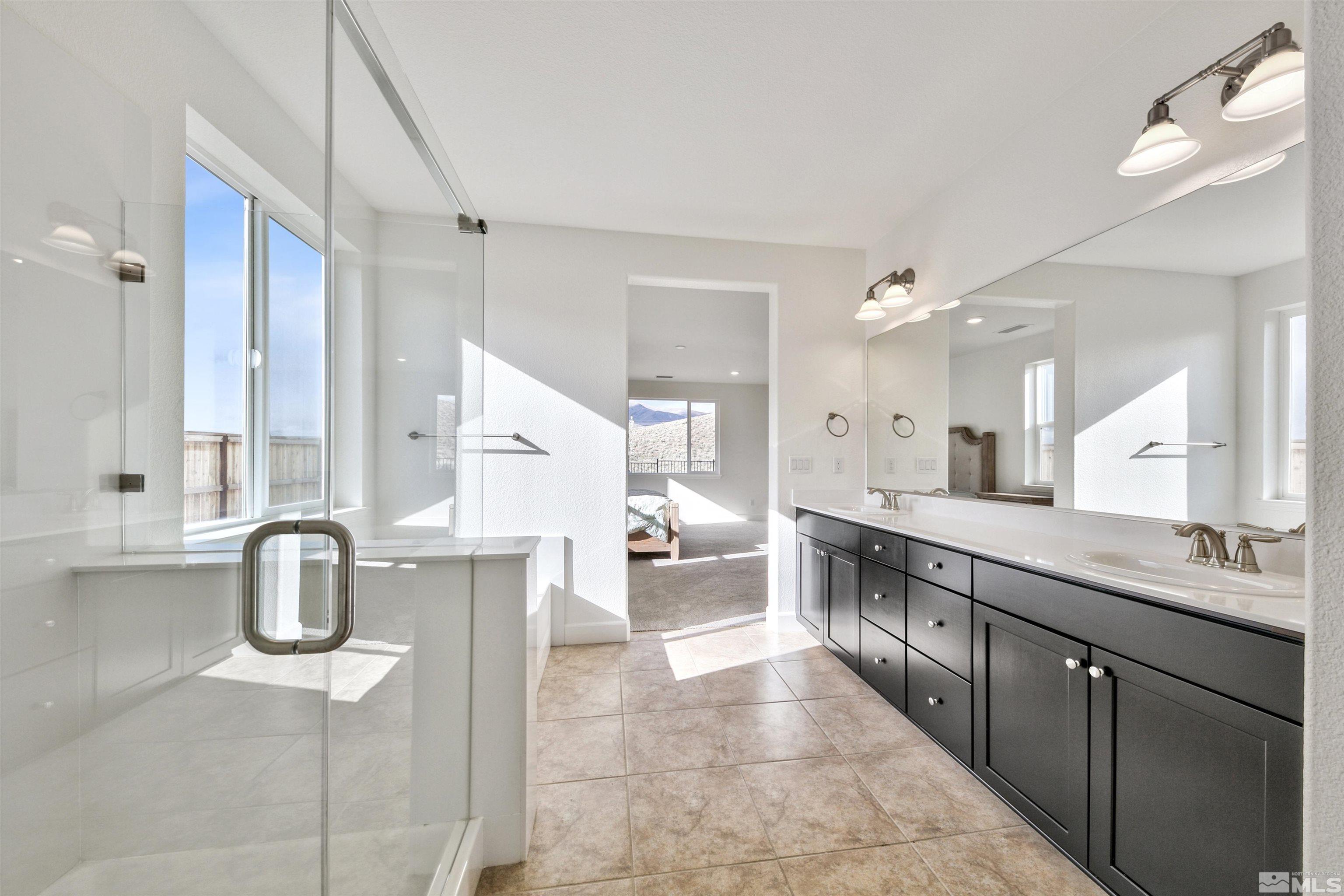 4505 High Pointe Drive Reno, NV 89521 - Photo 24 of 30 a large bathroom with a double vanity sink toilet and shower