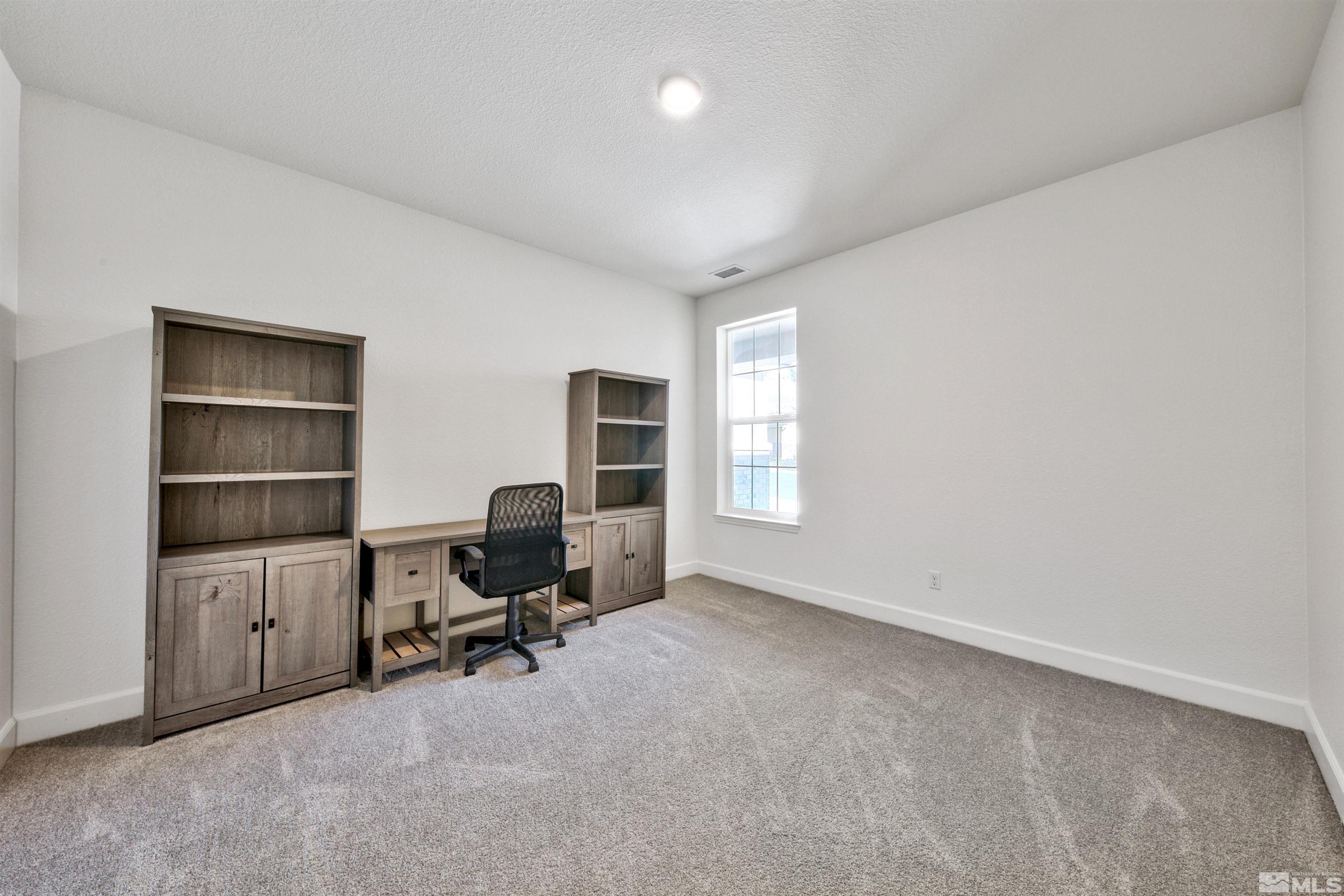 4505 High Pointe Drive Reno, NV 89521 - Photo 26 of 30 a view of a workspace with furniture and a window