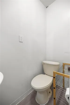 a white toilet sitting next to a shower