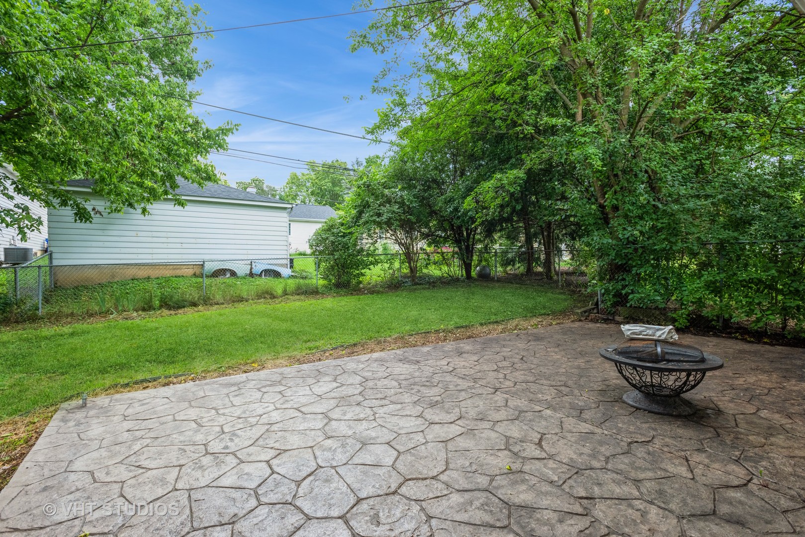 1217 South Naperville Road Wheaton, IL 60189 - Photo 3 of 13 a view of a backyard with table and chairs and plants