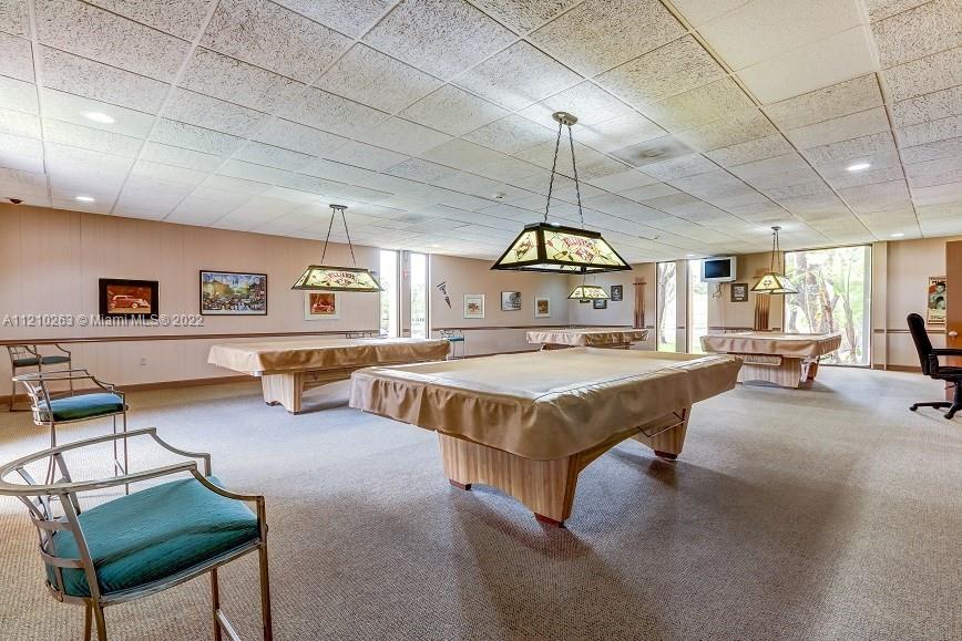 8650 Southwest 133rd Avenue Road, Unit 417 Miami, FL 33183 - Photo 14 of 14 a spacious bedroom with a bed a table and chair