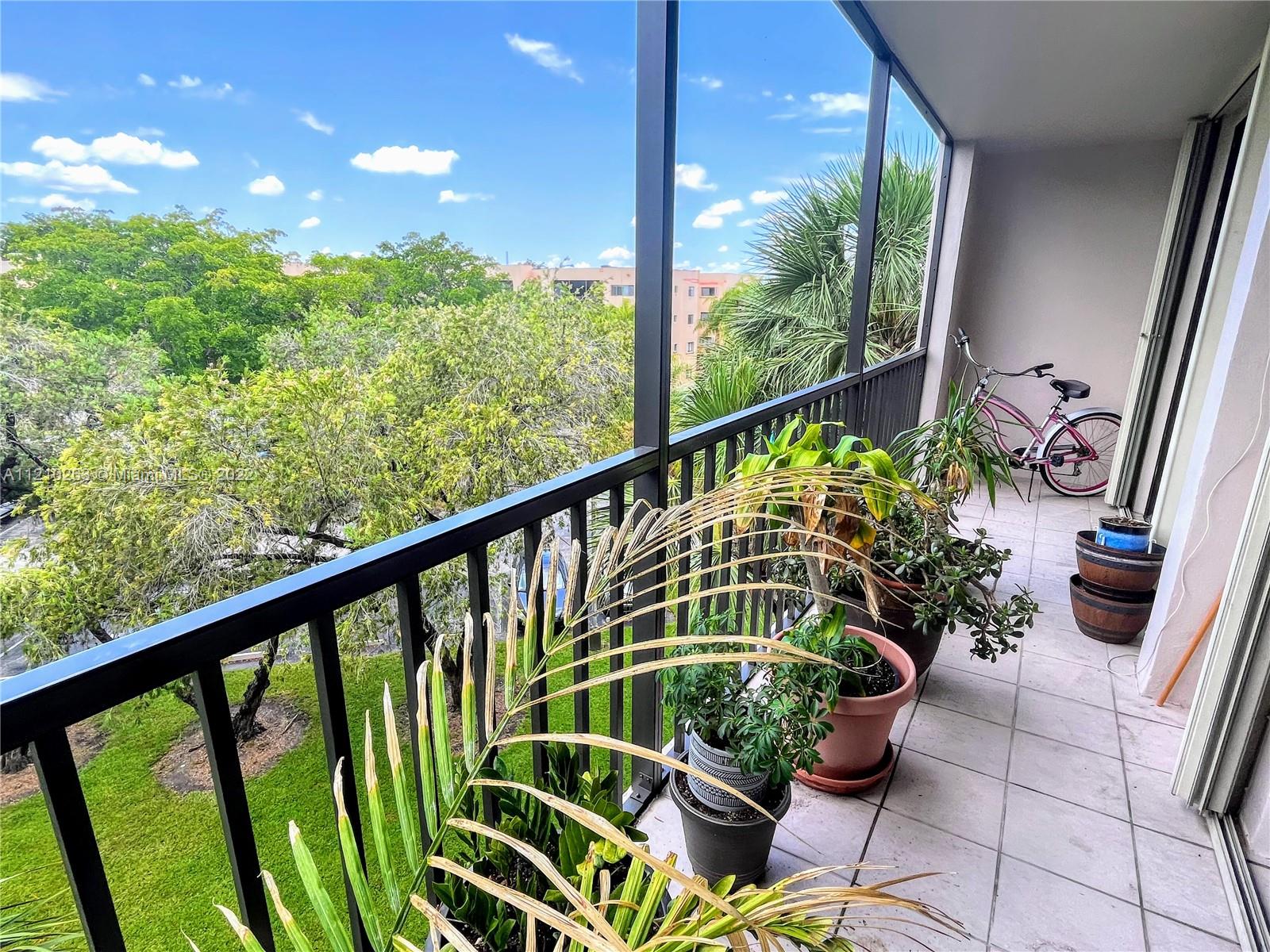 8650 Southwest 133rd Avenue Road, Unit 417 Miami, FL 33183 - Photo 5 of 14 a view of a chairs and table in the balcony