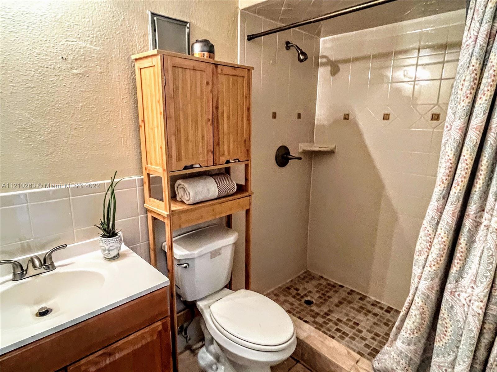 8650 Southwest 133rd Avenue Road, Unit 417 Miami, FL 33183 - Photo 8 of 14 a bathroom with a sink toilet and shower