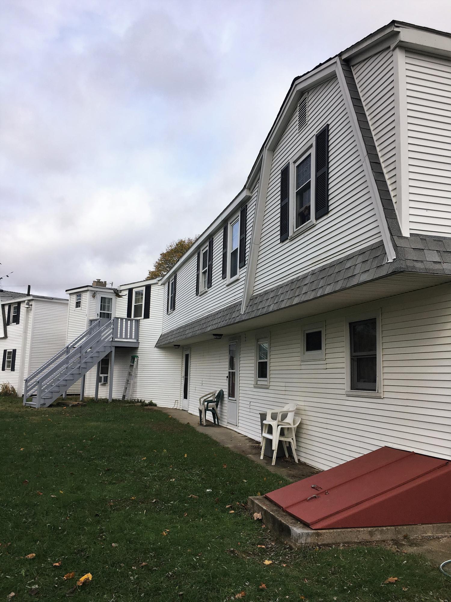 36 Oak Neck Road Hyannis, MA 02601 - Photo 2 of 4 a backyard of a house with table and chairs