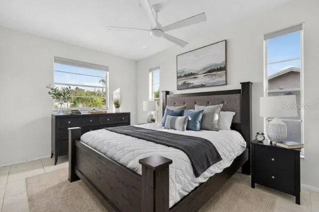 a bedroom with a bed and a window