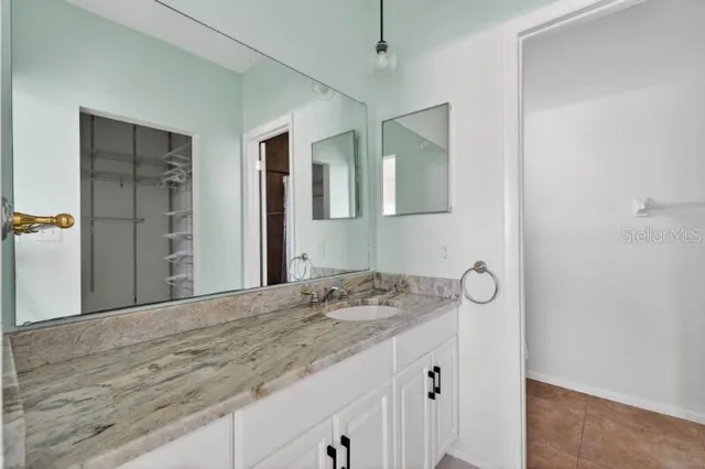 a bathroom with a sink a vanity and a mirror