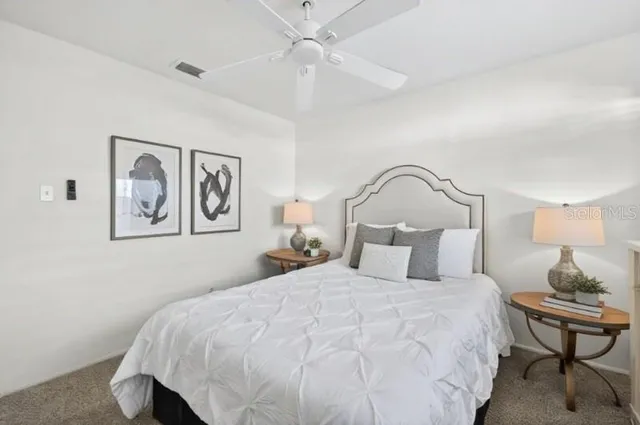 a bedroom with a bed and a painting on the wall